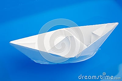 Paper ship in blue water