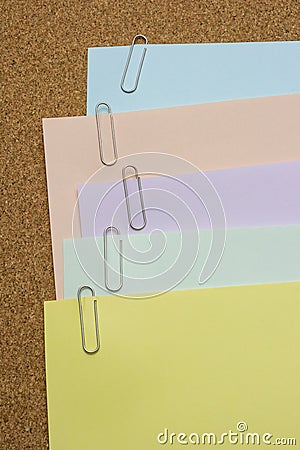 Papers with paper clip attached on the brown board