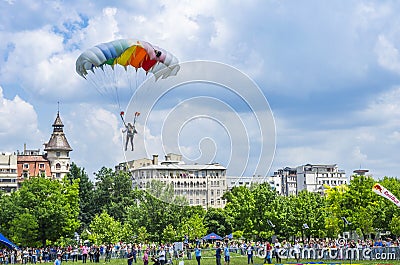 Parachute jumper landing in the city