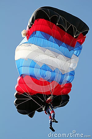 Parachutist on blue sky