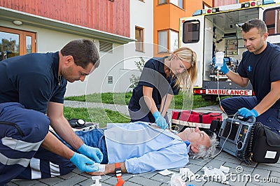 Paramedics giving firstaid to unconscious patient