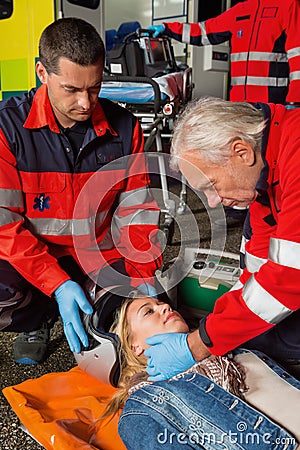 Paramedics removing helmet from motorcycle driver