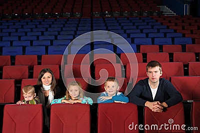 Parents with children watching a movie