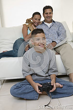 Parents Watching Son Play Video Games in living room front view