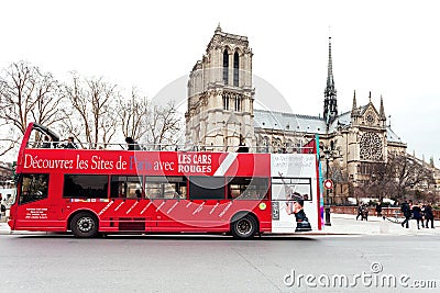 Red sightseeing bus and Paris Notre Dame