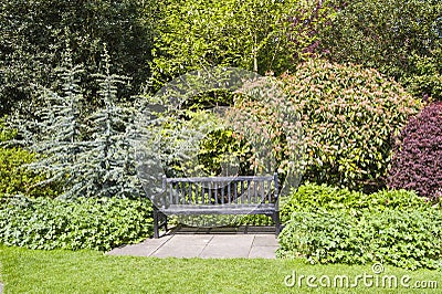 Park bench set in beautiful gardens