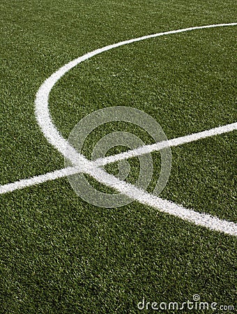 Part of a soccer field with green synthetic grass