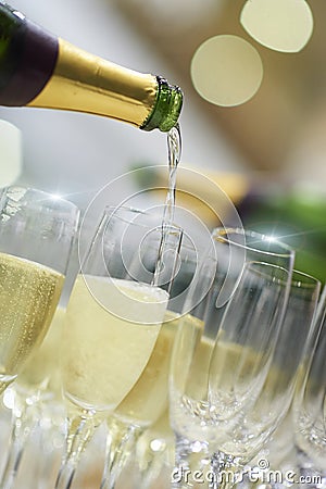 Party bottles pouring champagne into glasses