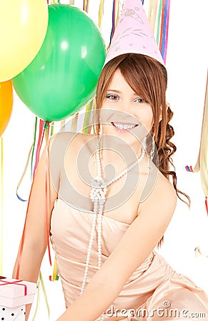 Party girl with balloons and gift box