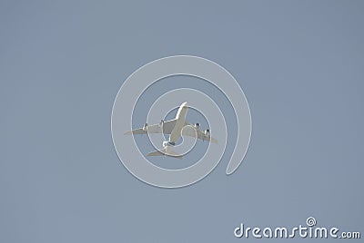 Passenger airplane from ground with blue cloudy sky background