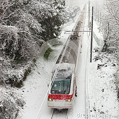 Passenger train moving along snow track