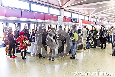 Passengers at the Baggage Carousel at the Airport Tegel