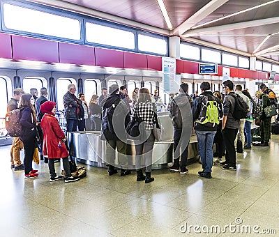 Passengers at the Baggage Carousel at the Airport Tegel