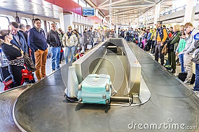 Passengers at the Baggage Carousel at the Airport Tegel