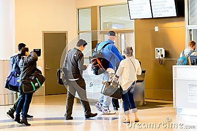 Passengers queued in line for boarding at departure gate