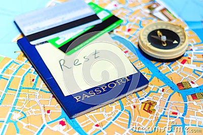 Passport, credit cards and compass on a map