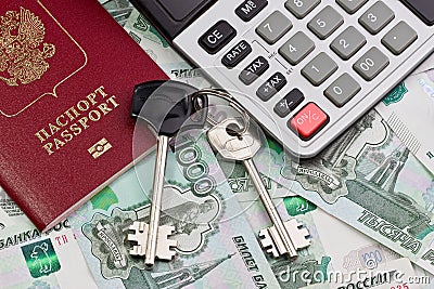 Passport, keys and the calculator on a background of money