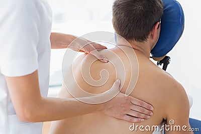 Patient being massaged by female therapist