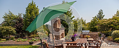 Patio outdoor kitchen and garden with green umbrella