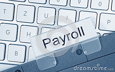 Payroll folder on computer keyboard