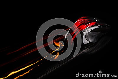 PC mouse in fast motion with flames and light trails.