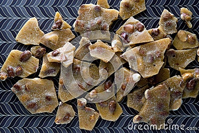 Peanut Brittle on brown pattern background