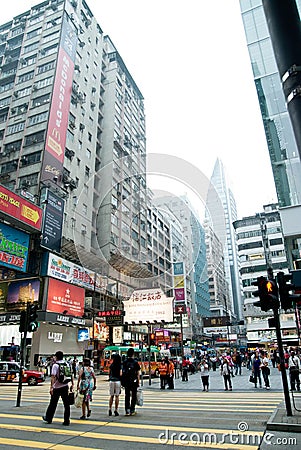 Pedestrians walking across Nathan Road street.