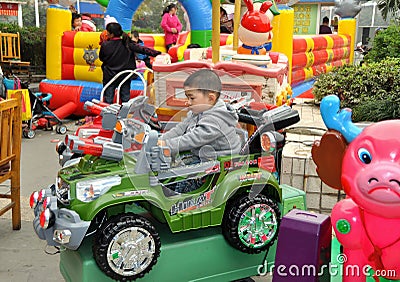 Pengzhou, China: Child in Play Car