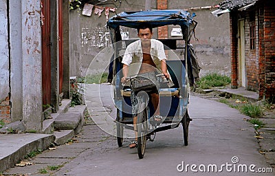 Pengzhou, China: Man Driving Bicycle Taxi