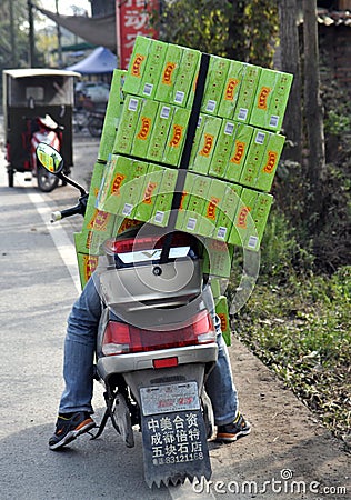 Pengzhou, China: Man on Motorcycle with Packages