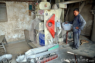 Pengzhou, China: Man Processing Rice
