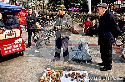 Pengzhou, China: Man Spinning Top