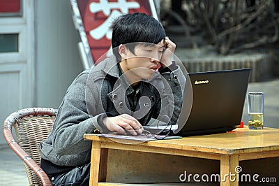 Pengzhou, China: Man Using Computer