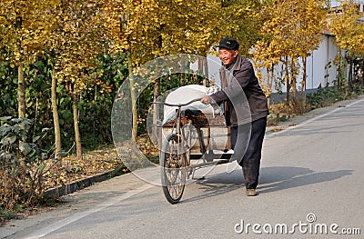 Pengzhou, China: Man Walking Bicycle Cart