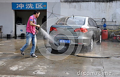 Pengzhou, China: Man Washing Car