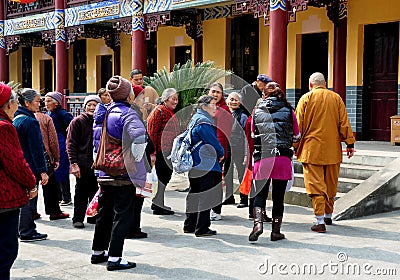 Pengzhou, China: Monk Leading Tourist Group