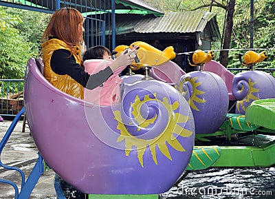 Pengzhou, China: Mother & Child at Amusement Park