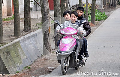 Pengzhou, China: Three Teens on Motorcycle