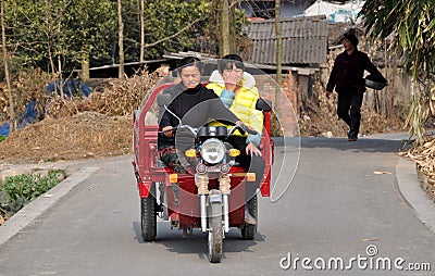 Pengzhou, China: Two Women Riding Motorcycle Cart