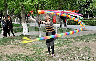 Pengzhou, China: Woman Spinning Top