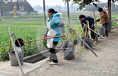 Pengzhou, China: Women Filling Water Buckets