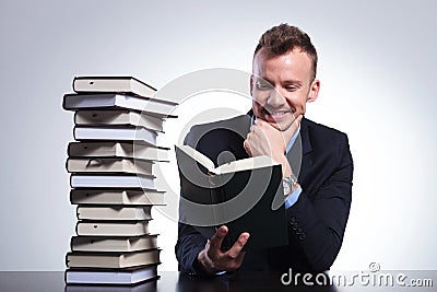 Pensive business man smiles while reading