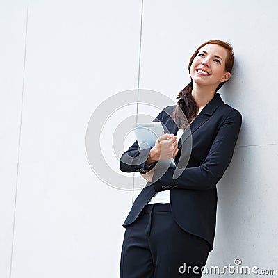 Pensive business woman with tablet
