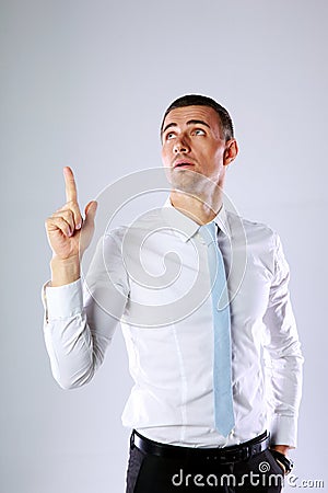 Pensive businessman showing finger up