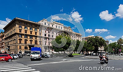 People and cars on the street in Rome, Italy.