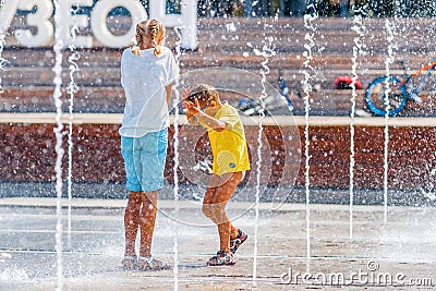 People cool themselves in the new fountain in Museon park