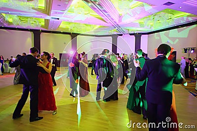 People dance in pairs in costumes and masks