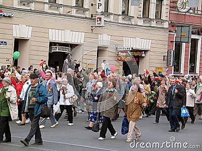 People of different ages walks on the street.