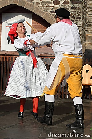 People dressed in Czech traditional garb dancing and singing.