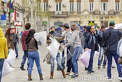 People fighting with pillows